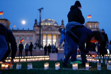 The Russia-Ukraine war worries Europe -- people form a peace sign with candles in front of the German Reichstag parliament  building in Berlin