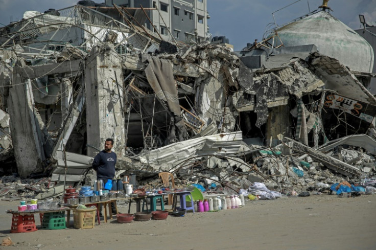 A vendor waits for customers along a street in Gaza City