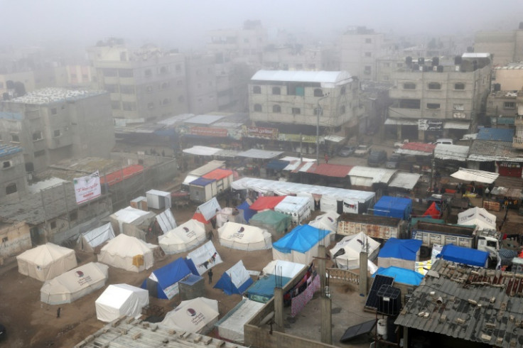Fog covers buildings and tents set up by displaced Palestinians in Rafah in the southern Gaza Strip