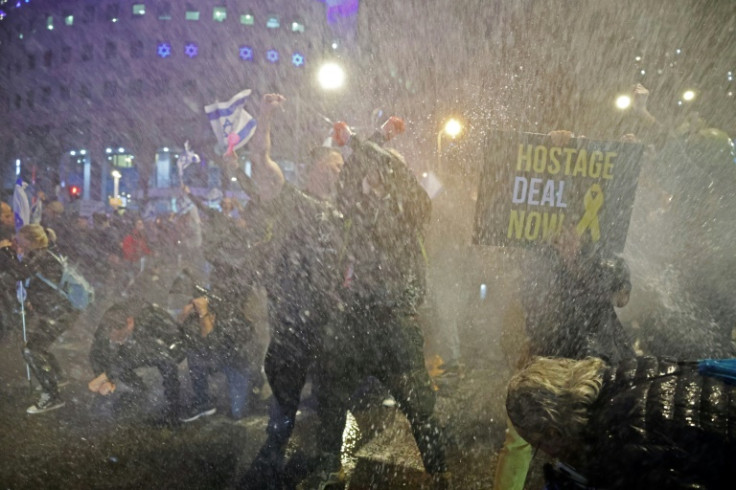 Israeli police use a water cannon to disperse protesters during an anti-government rally in Tel Aviv urging action to rescue the remaining hostages