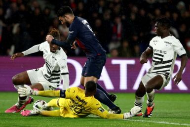Goncalo Ramos tumbles over Rennes goalkeeper Steve Mandanda to win a point-saving penalty