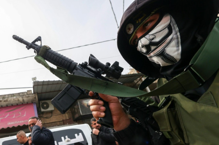 A gunman from the Al-Quds Brigades, the armed wing of the Islamic Jihad movement, in the funeral procession on February 23, 2024 of Palestinian men killed in an Israeli strike on Jenin in the occupied West Bank