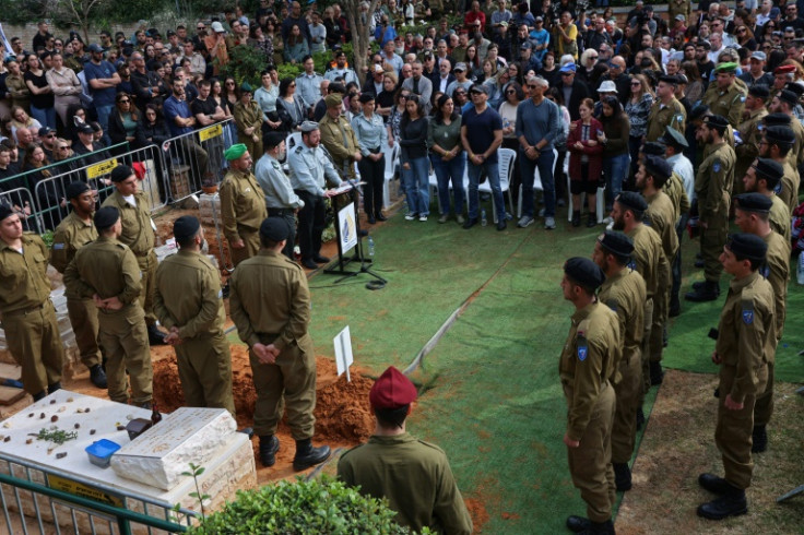 Relatives and friends of Israeli soldier Oz Daniel, 19, attend his funeral in Kfar Saba near Tel Aviv, after the army confirmed his death and a campaign group said his remains are still held in Gaza