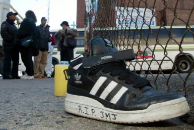 An Adidas sneaker bearing a mourner's message sits on the street outside the music studio in the Queens neighborhood where former Run-DMC member Jason Mizell, known as DJ Jam Master Jay, was shot dead