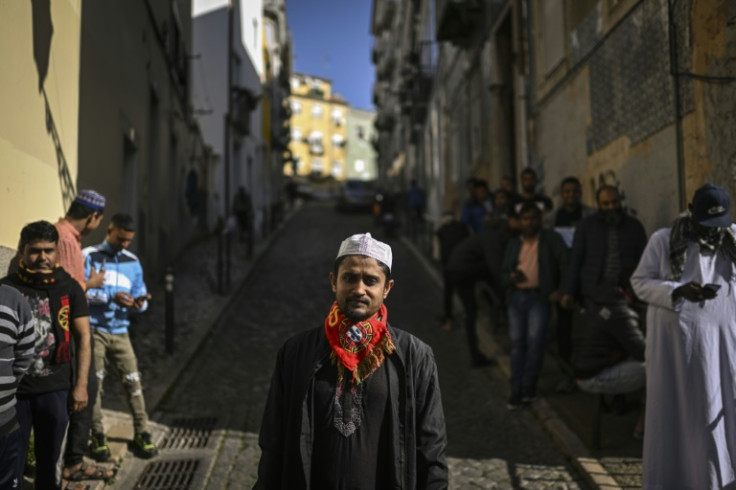 A young Muslim in a Portugal scarf queues to go to the mosque in 'Bangladesh Street' in Lisbon