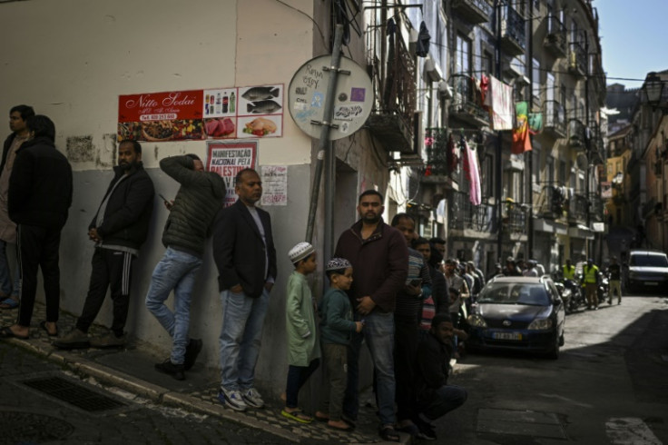 Muslims queue to enter a mosque in Lisbon's Mouraira neighbourhood