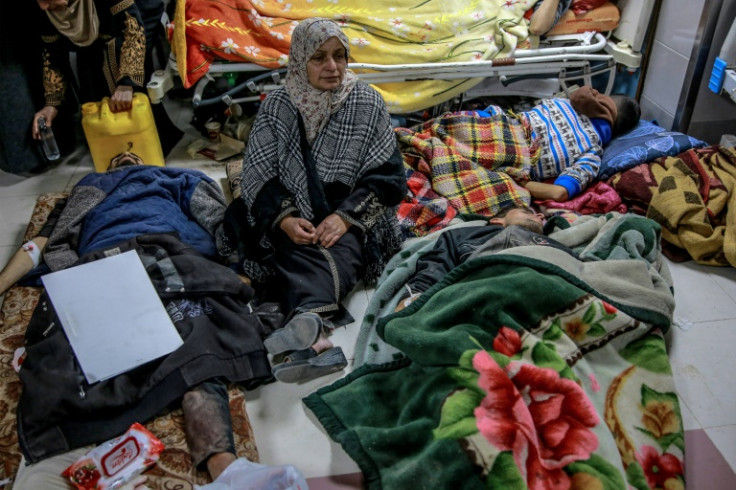 A woman sits among Palestinians at Al-Shifa hospital in Gaza City after the incident in Gaza City