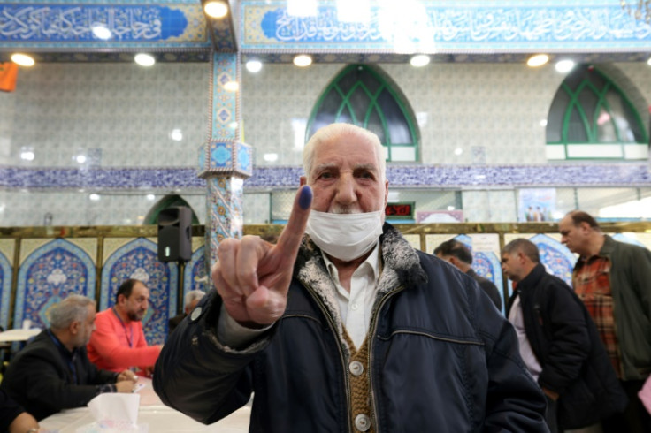 An Iranian man shows his ink-stained finger after casting his ballot -- more than 61 million people are eligible to vote in the country of 85 million