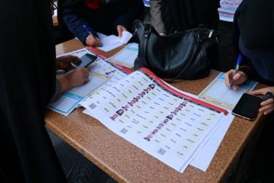 Iranian women fill out their ballots -- analysts expect conservatives and ultra-conservatives to dominate parliament once again
