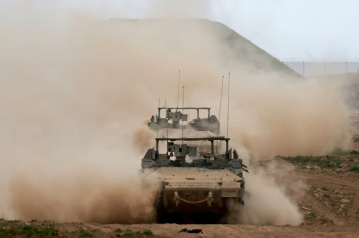 Israeli army vehicles, seen from Israel leaving the Gaza Strip