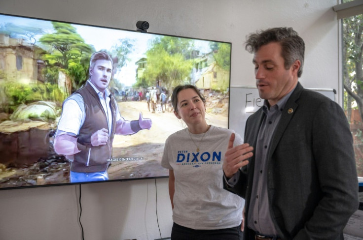 Peter Dixon talks with communications director Taylor Hebble; on the screen behind them is an artificially generated picture of Dixon, a military veteran, in Afghanistan