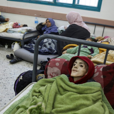 Ten-year-old Palestinian boy, Yazan al-Kafarneh, displaced from Beit Hanun and suffering from a pre-existing condition, lies on a hospital bed at Al-Awda clinic in Rafah; he died on March 4 severe malnourishment and insufficient healthcare