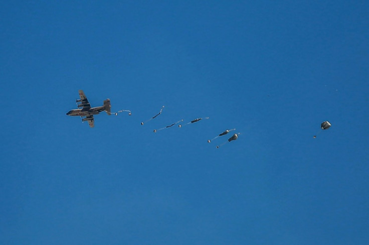 An aircraft airdrops aid parcels over the northern Gaza Strip