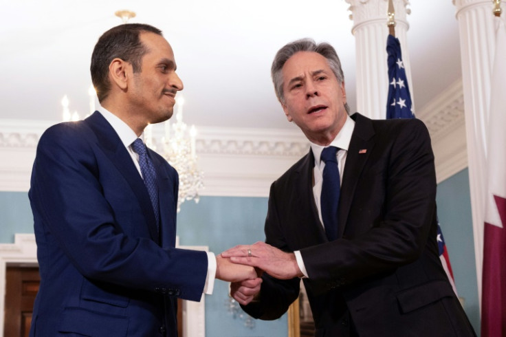 Qatari Prime Minister and Foreign Minister Mohammed Bin Abdulrahman Al Thani shakes hands with US Secretary of State Antony Blinken