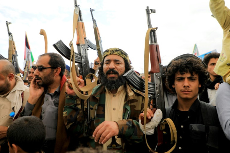 Yemenis brandish weapons as they march in the Huthi-run capital Sanaa on March 1, 2024, in support of Palestinians amid ongoing battles between Israel and the militant Hamas group in the Gaza Strip