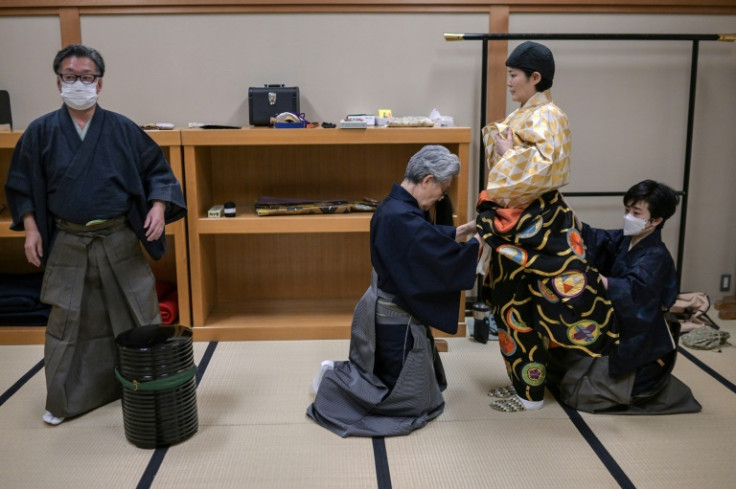 Mayuko Kashiwazaki (2nd R) gets into costume before a dress rehearsal for 'Dojoji', a drama about the revenge of a betrayed woman