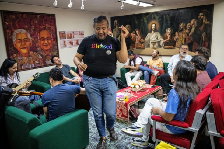 Wearing a T-shirt emblazoned with the word "blessed" in rainbow colors, LGBTQ activist Eduardo Andrade leads a choir practice in Mexico City