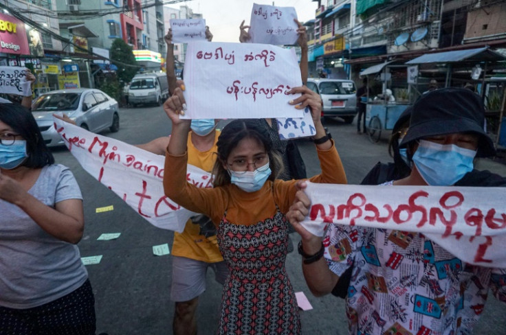 Student activist Lin Lin holds up a sign as she takes part in a 2021 demonstration against the military coup in Yangon