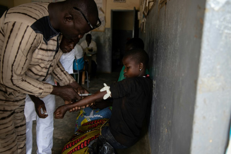A girl is given an injection to cure malaria in Ziniare, north east of Burkina Faso's capital Ouagadougou, on August 20, 2019
