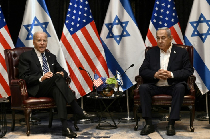 US President Joe Biden listens to Israel's Prime Minister Benjamin Netanyahu as he joins a meeting of the Israeli war cabinet in Tel Aviv on October 18, 2023