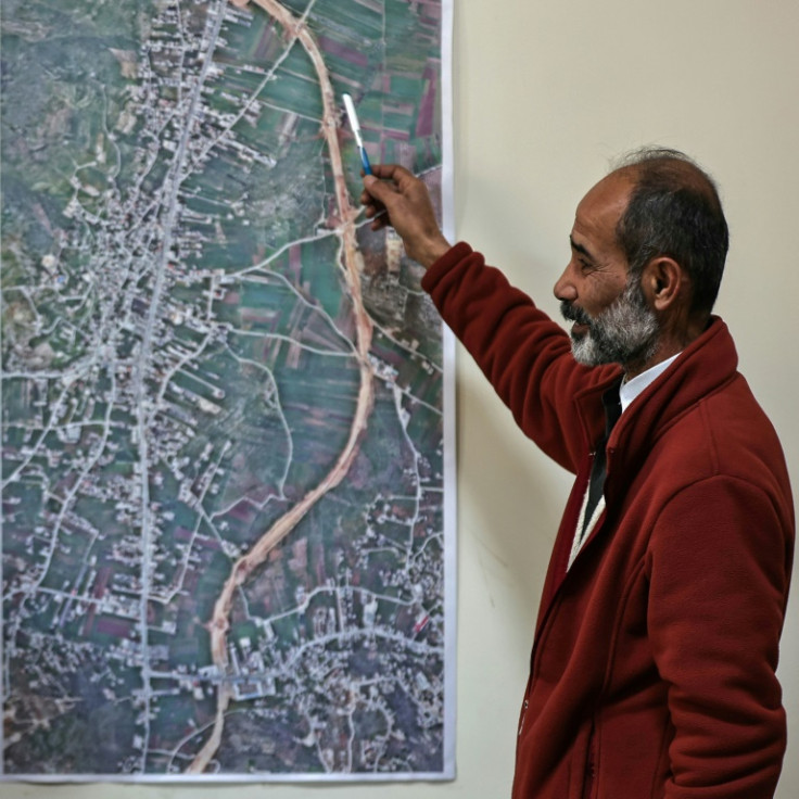 Huwara mayor Jihad Odeh shows the Israeli bypass that has diverted traffic from the town
