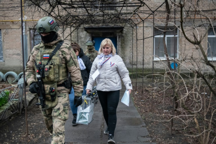 Armed soldiers accompanied local election officials in parts of Ukraine under Russia's control