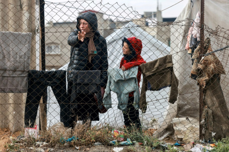 A woman and child stand in Rafah in the southern Gaza Strip