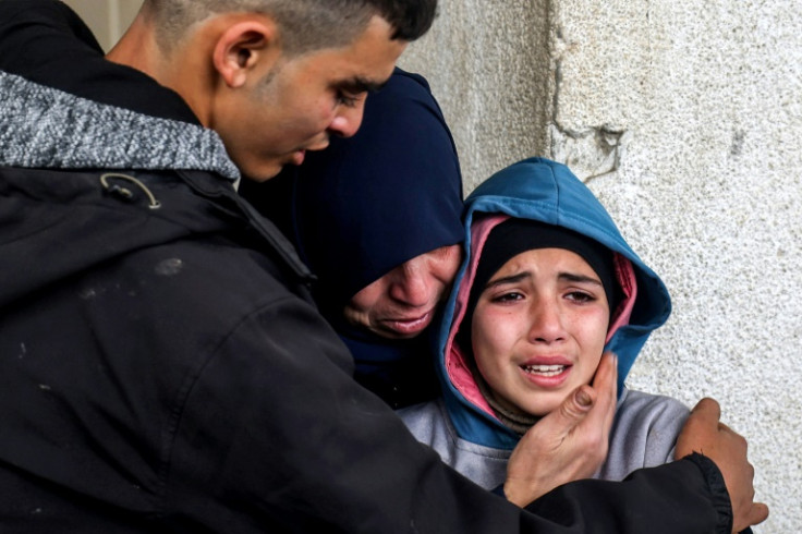 A group of Gazans mourn relatives killed during overnight Israeli bombardment, at al-Najar Hospital in Rafah in the southern Gaza Strip on March 19, 2024