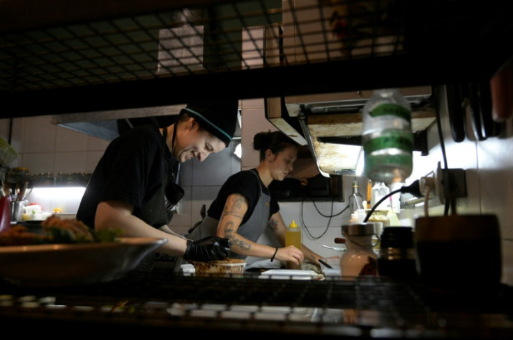 Agustina Bovi (L) cooks at the small vegan restaurant 'Yedra,' in Buenos Aires, but even with another job on the side she's living through her 'worst period from an economic point of view'