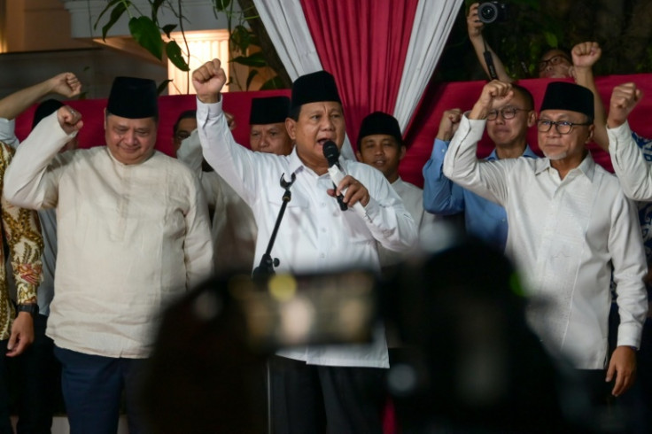 Indonesian defence minister Prabowo Subianto, who stormed to victory in the country's presidential election, gestures to cheering supporters in a speech in Jakarta after his win was officially confirmed