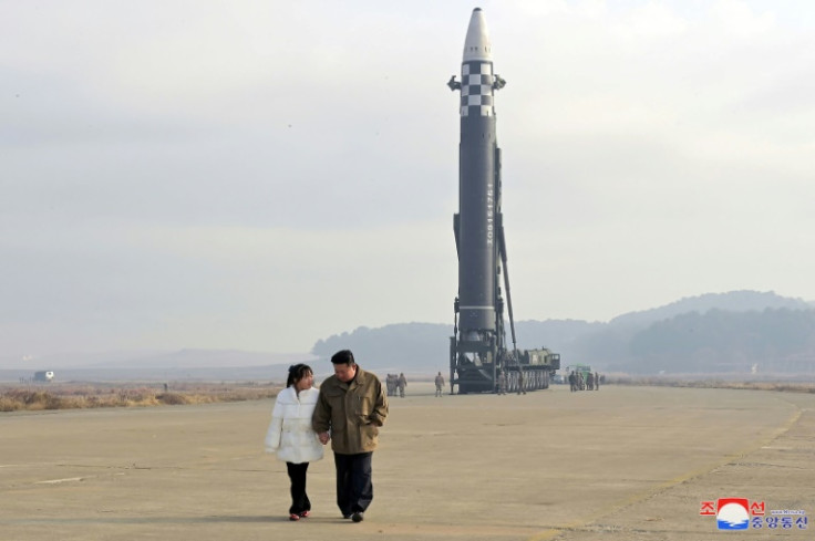 North Korea's leader Kim Jong Un (R) walks with daughter Ju Ae as he inspects a new intercontinental ballistic missile