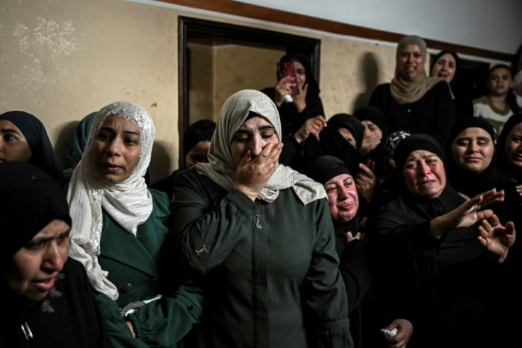 Palestinian women grieve over the body of one of four men killed in an Israeli raid in the occupied West Bank