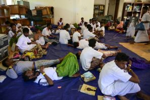 Newly arrived Rohingya refugees rest at a former Red Cross office in Indonesia's Aceh