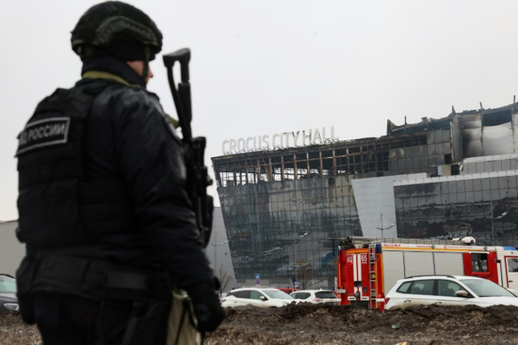 A law enforcement officer patrols the scene of Russia's deadliest attack in two decades