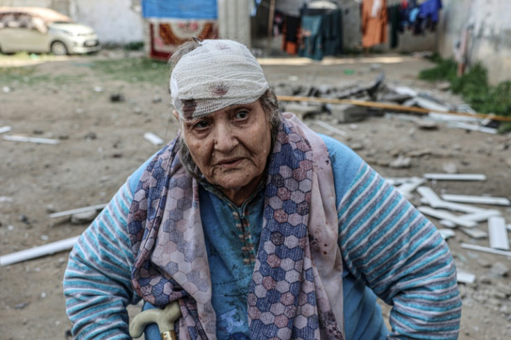 Palestinian Hoda al-Arouqi, 75, injured during Israeli bombardment, inspects the damage to her home in Rafah