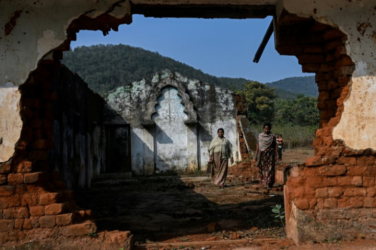 Christian villagers walk through a destroyed Roman Catholic Church in Kandhamal district of India's Odisha state