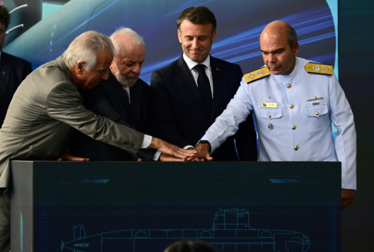 (L-R) Brazil's Defence Minister Mucio Monteiro Filho, Brazil's President Luiz Inacio Lula da Silva, France's President Emmanuel Macron and Brazil's Navy Commander, Admiral Marcos Sampaio Olsen, launch the Tonelero submarine at the Itaguai naval base