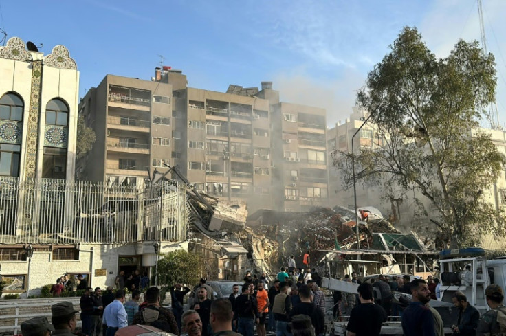 Emergency and security personnel gather at the site of strikes which hit a building adjacent to the Iranian embassy in Syria's capital Damascus, on April 1, 2024