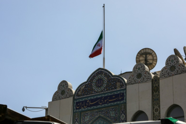 The Iranian national flag flies at half-mast at the adjacent embassy in Damascus