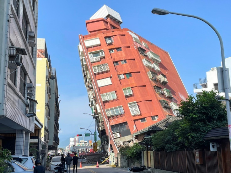 A Taiwan's Central News Agency photo shows people looking at a damaged building in Hualien, after a major earthquake hit Taiwan's east