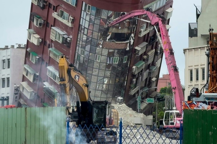 Heavy equipment is used to demolish the Uranus building, which was damaged in quake in Hualien