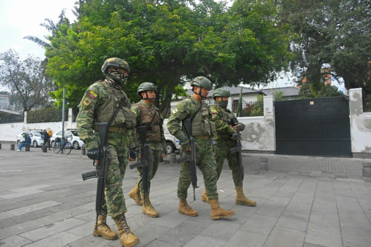 Soldiers patrol in front of the entrance of the Mexican embassy in Ecuador before the arrest of Jorge Glas