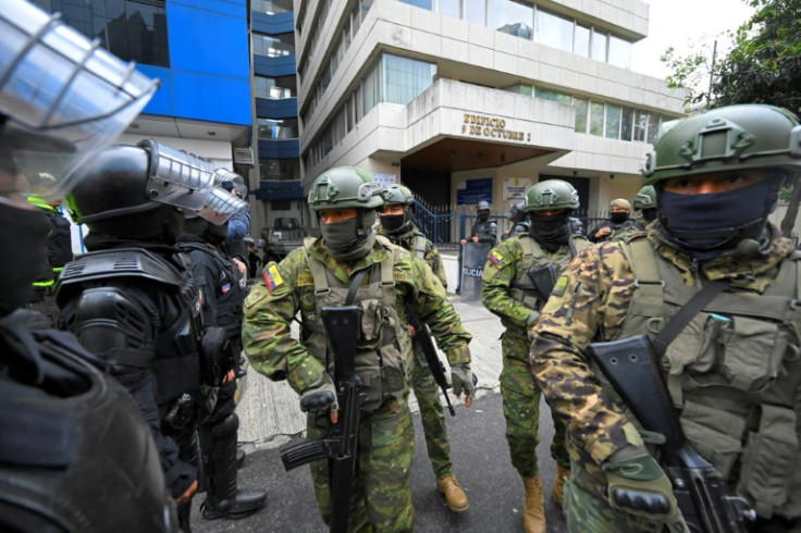 Military and police officers are seen as former Ecuadorian vice president Jorge Glas is transferred from the Public Prosecutor's Office in Quito on April 6, 2024 after being arrested at the Mexican embassy the day before