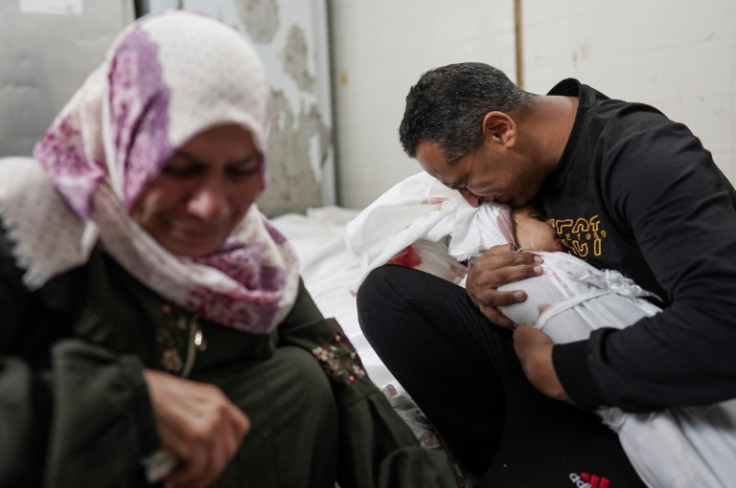 Palestinians mourn family members killed in overnight Israeli bombardment on the Nuseirat refugee camp in central Gaza, at the al-Aqsa Martyrs Hospital in Deir el-Balah on April 10, 2024