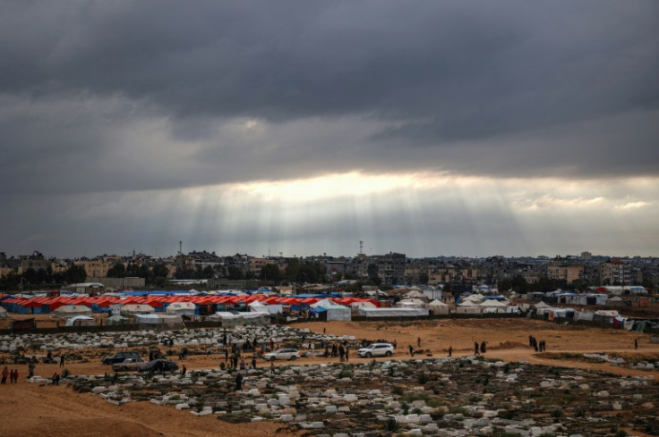 Palestinians visit the graves of loved one at the start of the Eid al-Fitr festival