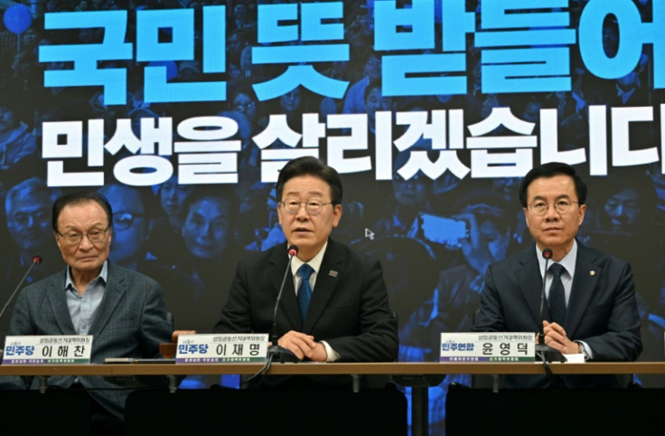 South Korea's main opposition Democratic Party leader Lee Jae-myung (C) speaks on Thursday following his big election victory