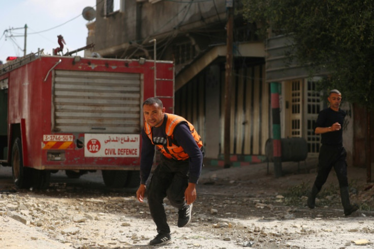 Palestinian firefighters in Nuseirat respond to an Israeli bombardment
