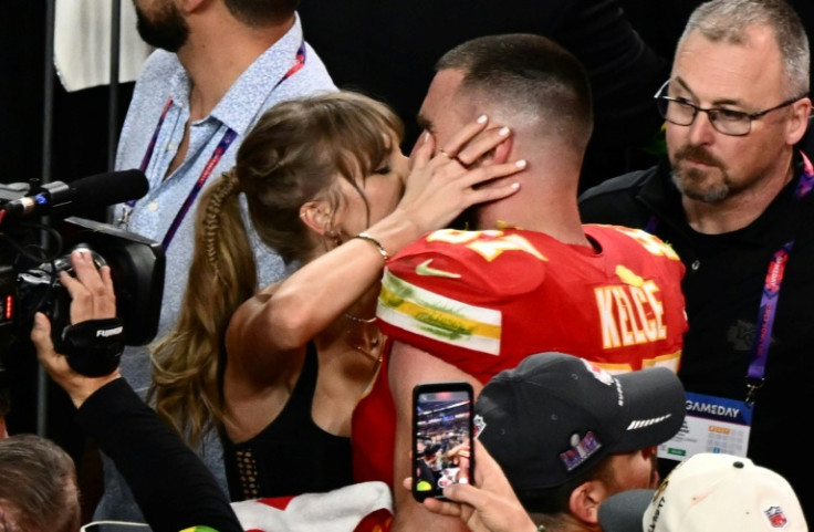 Taylor Swift, shown here kissing Travis Kelce at the 2024 Super Bowl, was spotted at Coachella similarly canoodling with her NFL boyfriend during the set of Bleachers, which is fronted by her producer