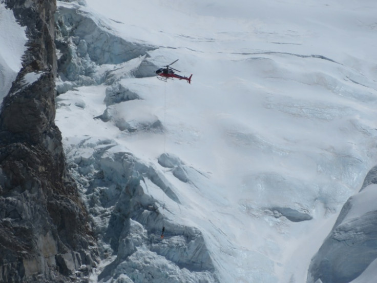 A Nepalese rescue helicopter helps to move an injured climber at Everest base camp on April 18, 2014