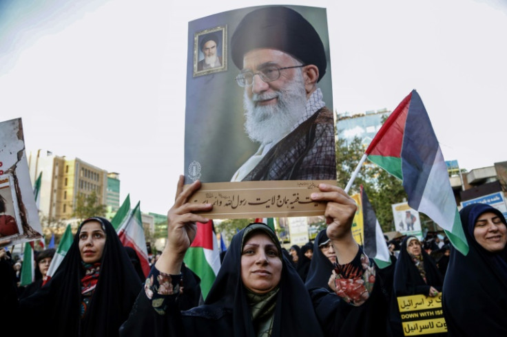 Iranians hold a portrait of supreme leader Ayatollah Ali Khamenei during a celebration following Iran's missiles and drones attack on Israel